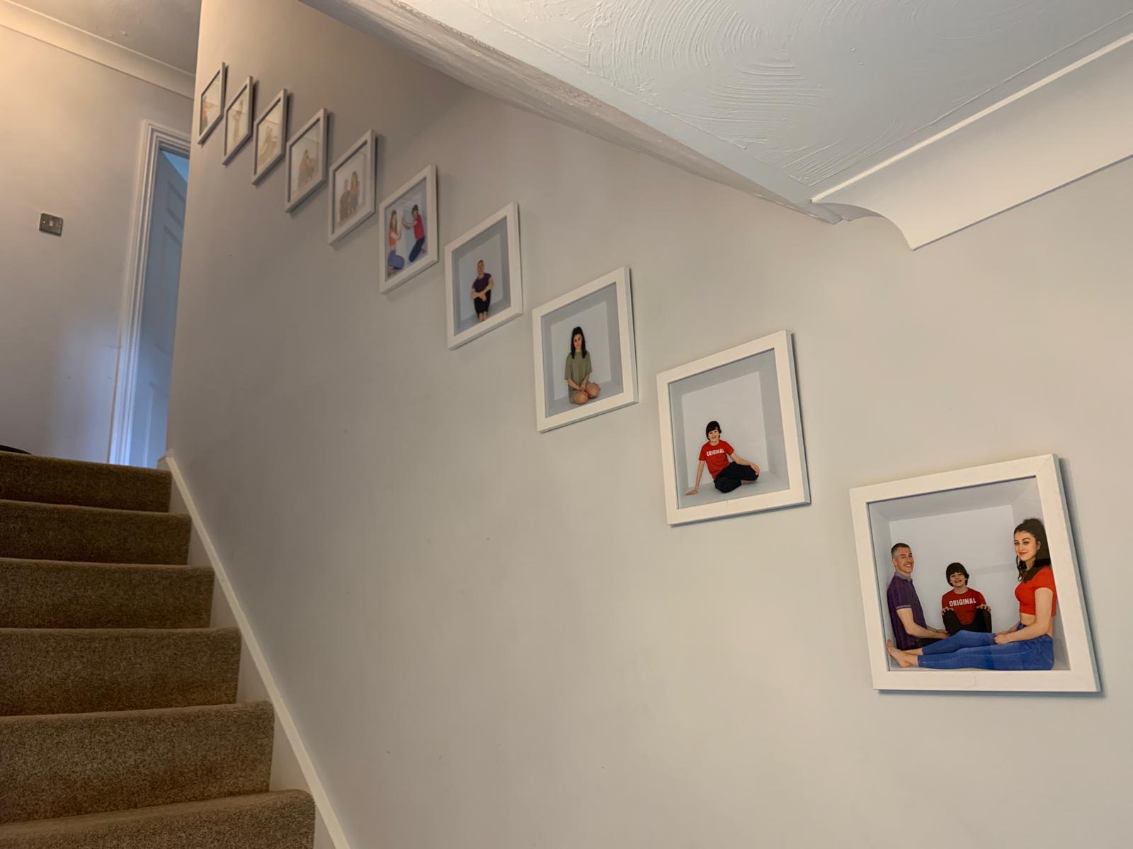 Image of 9 framed photos on stairs wall